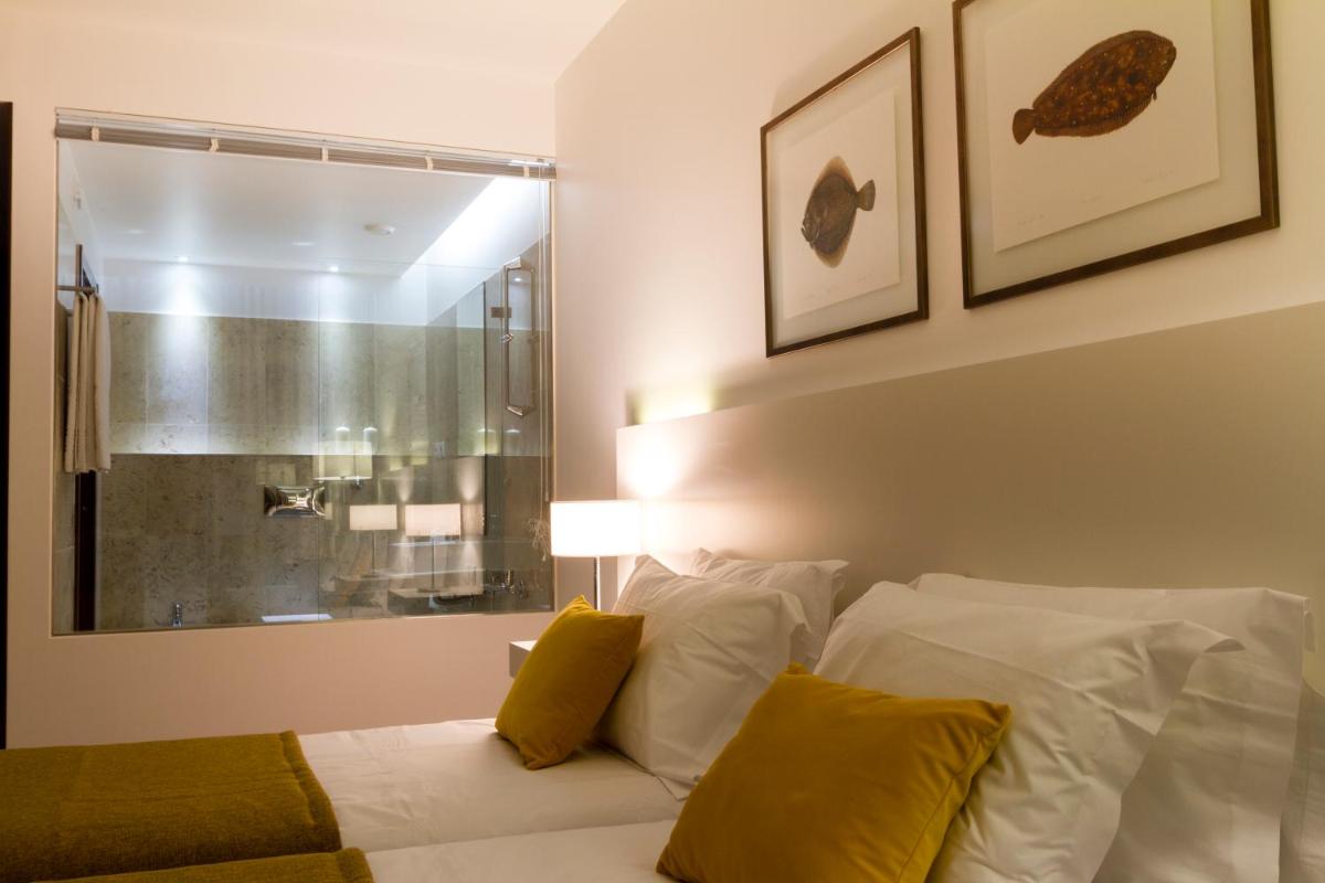 Uma cama ou camas num quarto em Hotel Vila D'Óbidos