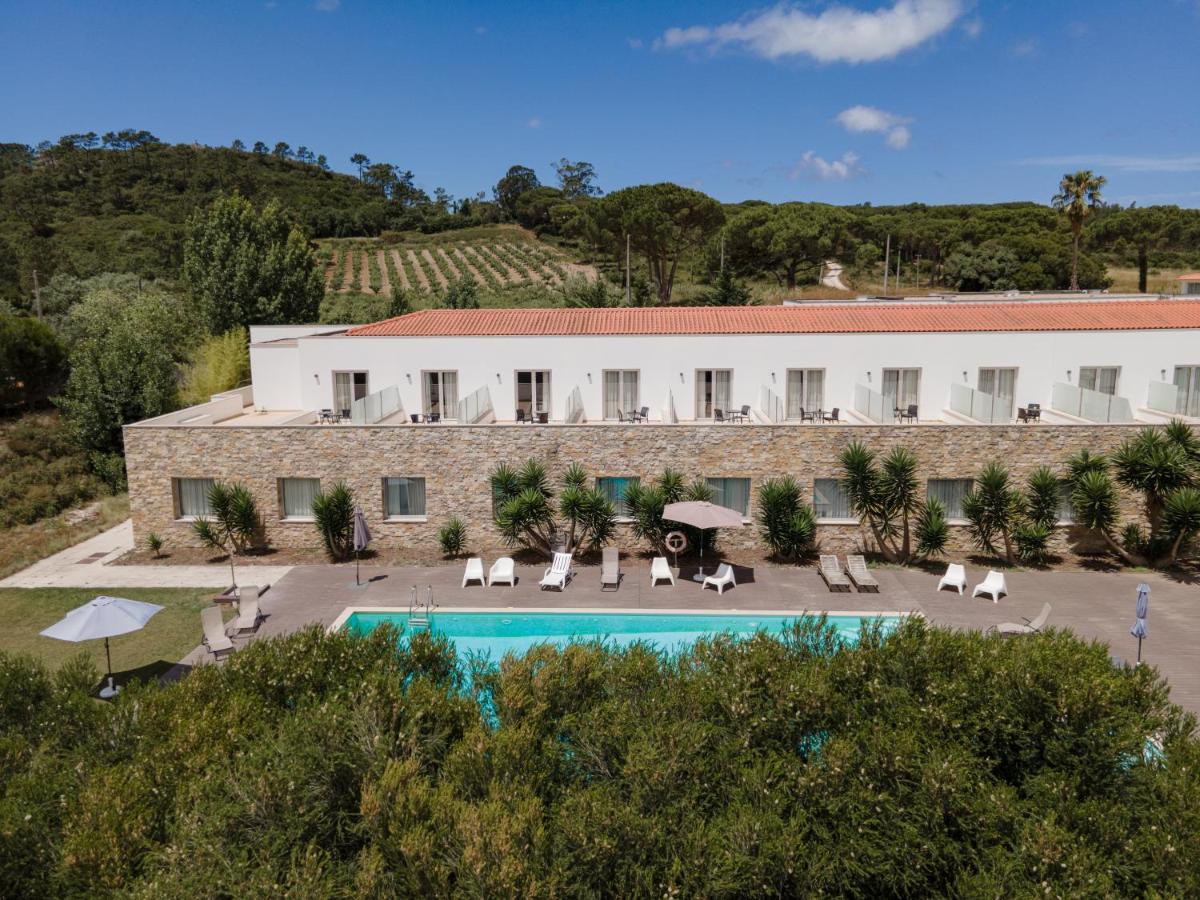 uma vista exterior do hotel e da piscina em Hotel Vila D'Óbidos em Óbidos