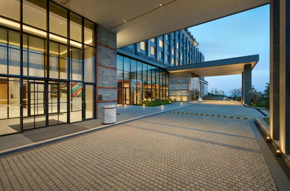 an external view of a building with a walkway at Hyatt Regency Dehradun Resort and Spa in Dehradun