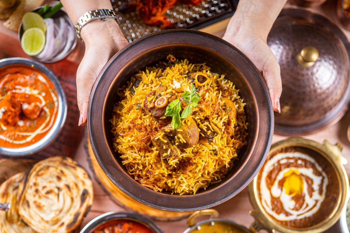a person holding a bowl of food on a table at Hyatt Place Jaipur Malviya Nagar in Jaipur a person holding a bowl of food on a table at Hyatt Place Jaipur Malviya Nagar in Jaipur