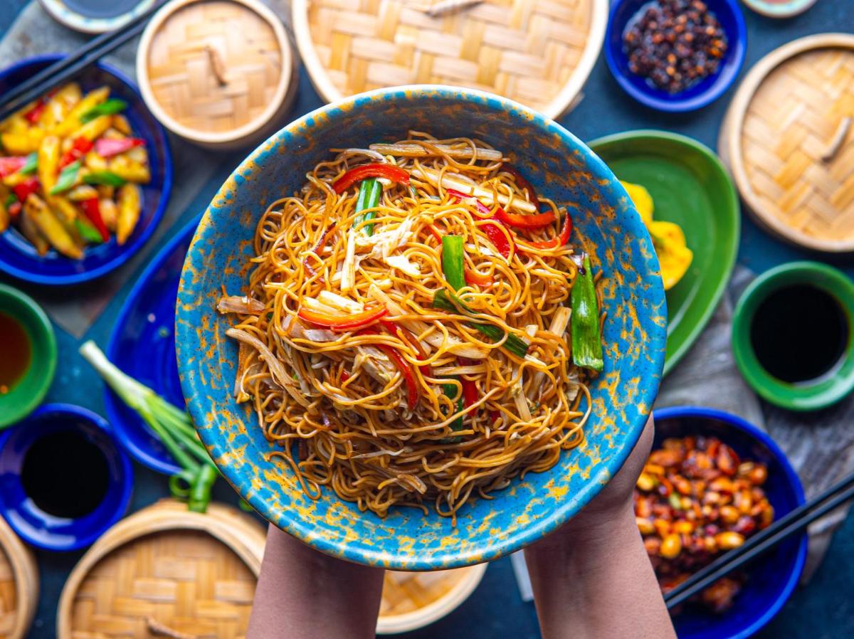 a person holding up a bowl of noodles at Hyatt Place Jaipur Malviya Nagar in Jaipur a person holding up a bowl of noodles at Hyatt Place Jaipur Malviya Nagar in Jaipur