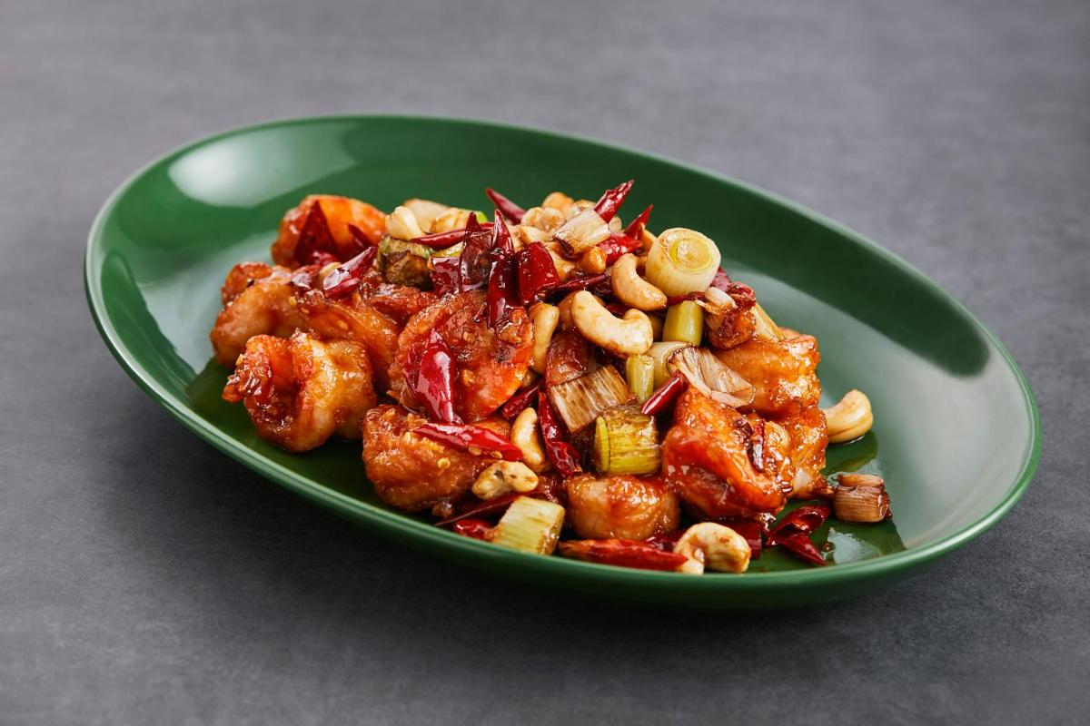a green bowl of food on a table at Hyatt Place Jaipur Malviya Nagar in Jaipur a green bowl of food on a table at Hyatt Place Jaipur Malviya Nagar in Jaipur