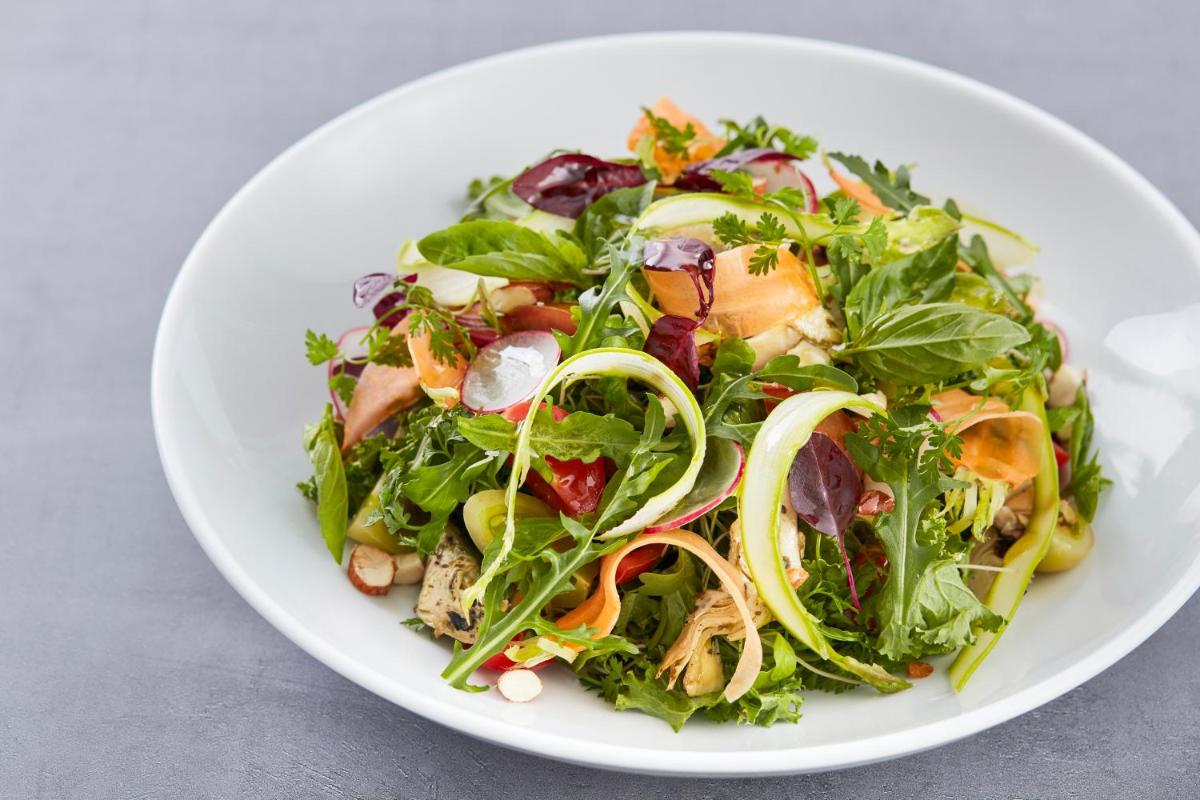 a salad in a white plate on a table at Hyatt Place Jaipur Malviya Nagar in Jaipur a salad in a white plate on a table at Hyatt Place Jaipur Malviya Nagar in Jaipur
