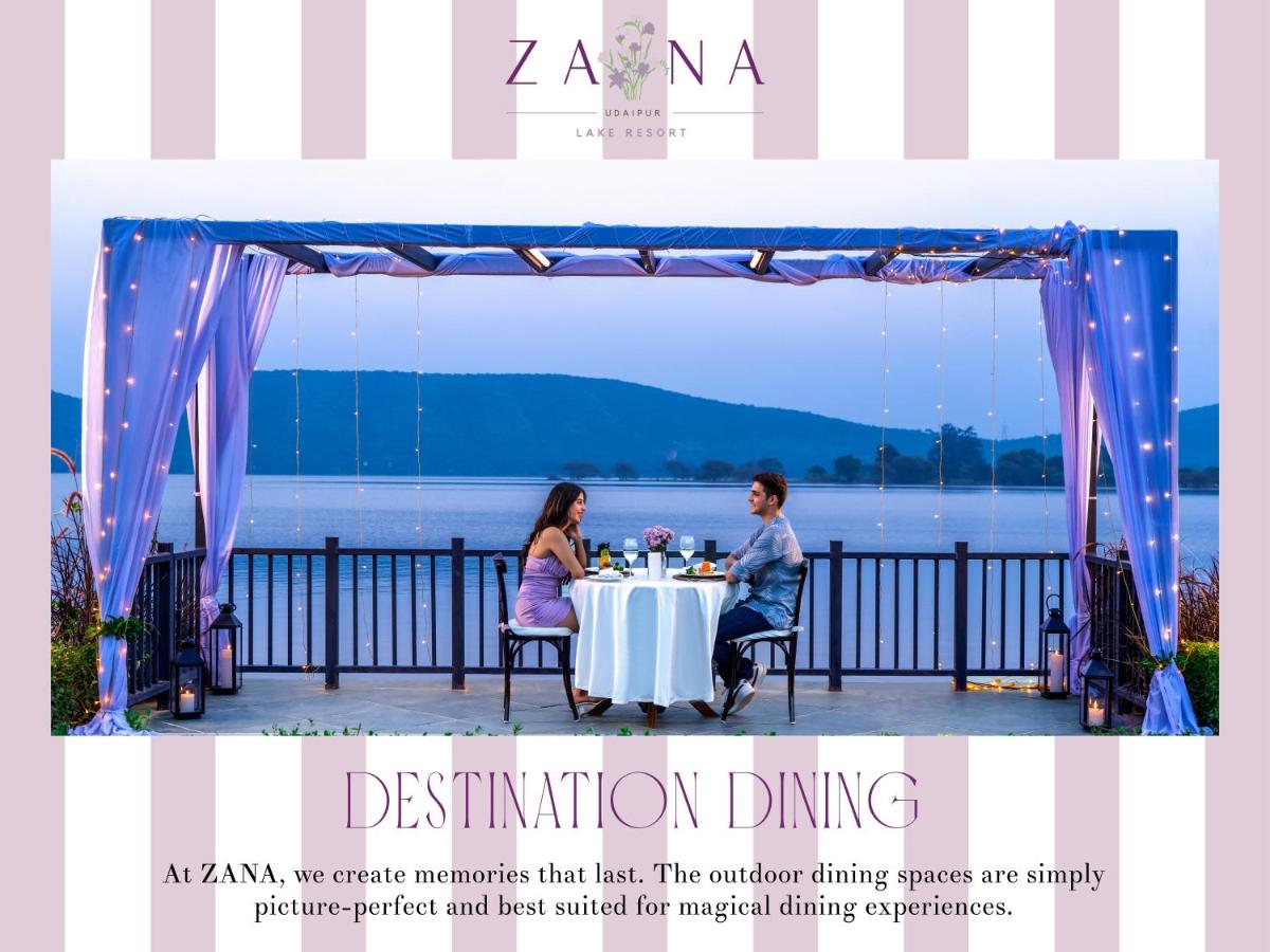 a man and woman sitting at a table under a tent at ZANA Lakeview Resort - most scenic lakeside resort in Udaipur