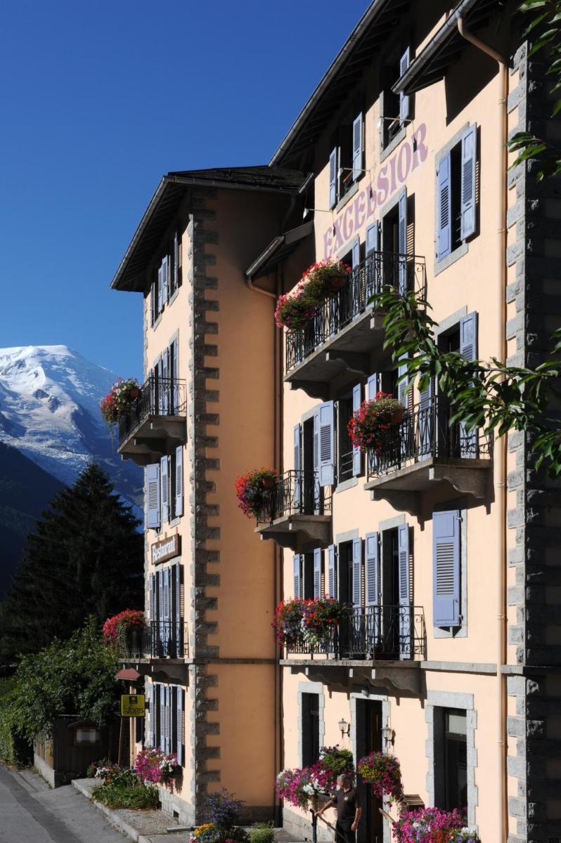 un hôtel dans les montagnes avec des fleurs sur les balcons dans l'établissement Excelsior Chamonix Hôtel & Spa, à Chamonix-Mont-Blanc