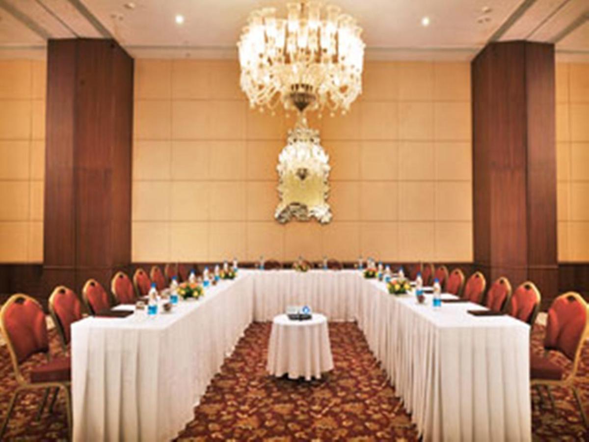 a row of tables in a room with chairs and a chandelier at The Grand Imperial - Heritage Hotel in Agra +58 photos