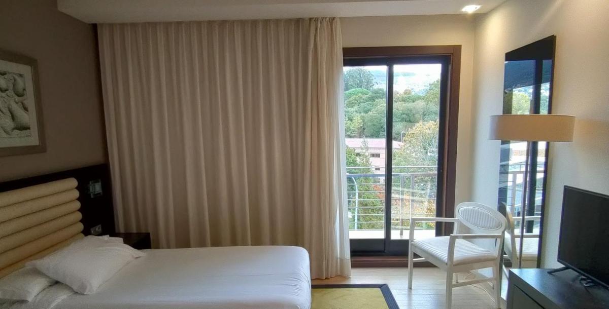 Cama o camas de una habitación en Hotel Bienestar Moaña