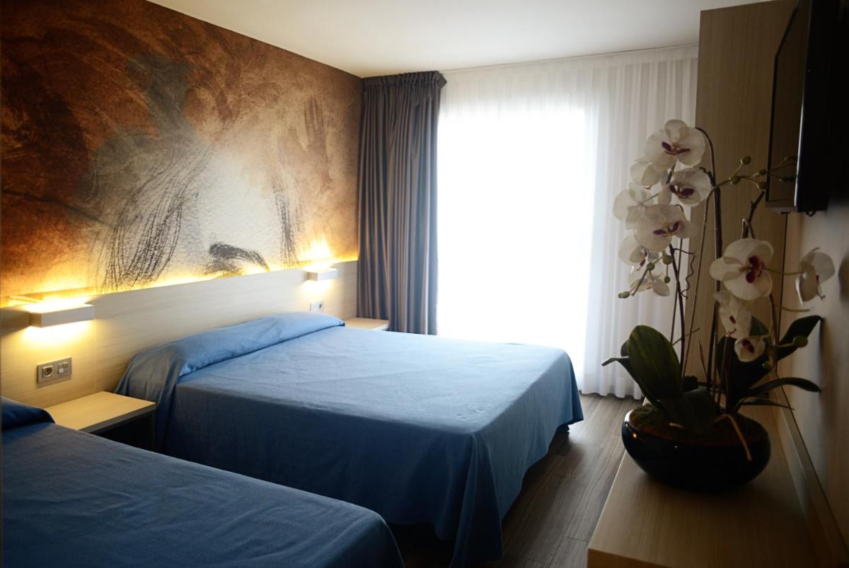 Cama o camas de una habitación en Hotel Riviera