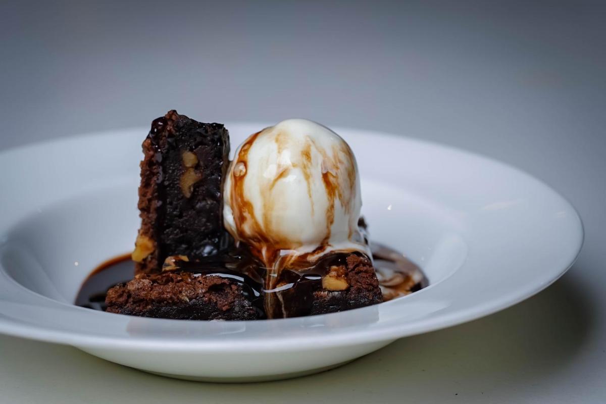 a chocolate dessert with an ice cream on a plate at Crowne Plaza Pune City Centre by IHG in Pune
