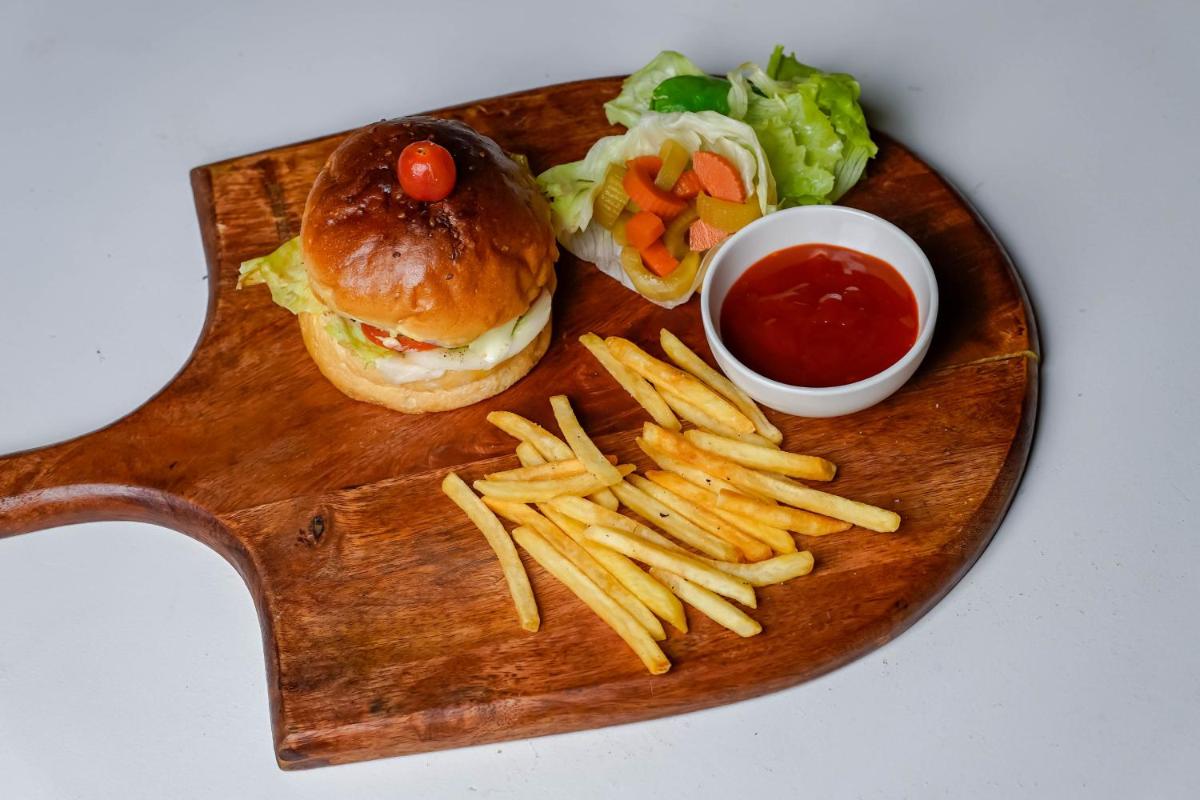 a plate of food with a sandwich and french fries at Crowne Plaza Pune City Centre by IHG in Pune