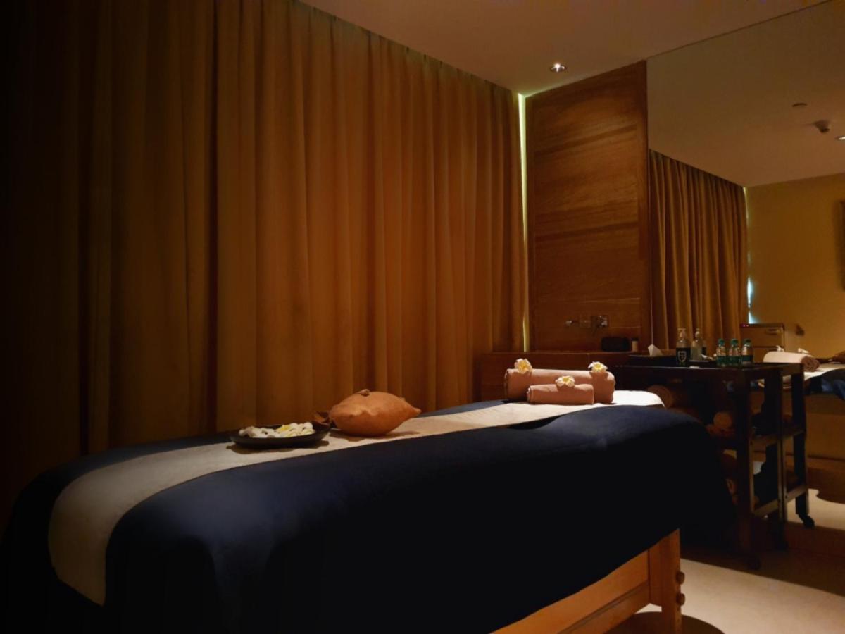 a bedroom with a bed with a teddy bear on it at Holiday Inn Mumbai International Airport by IHG in Mumbai