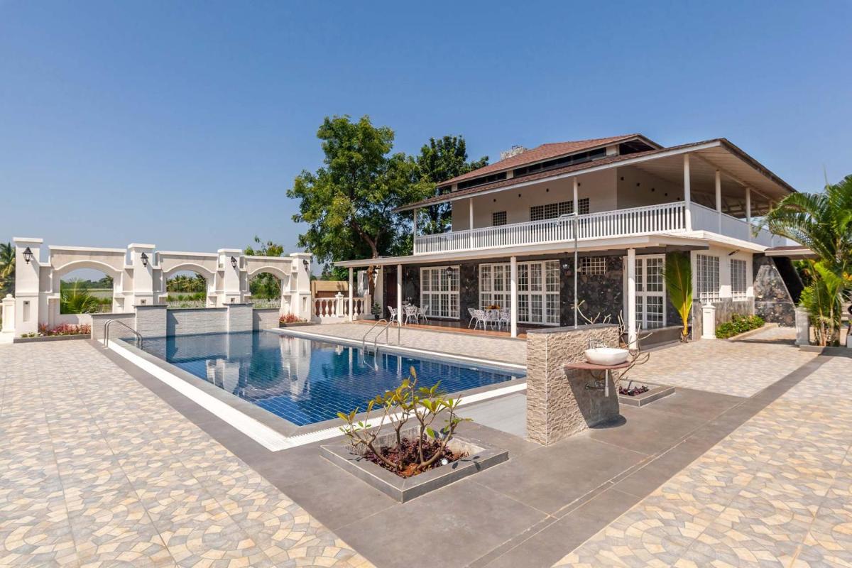 StayVista's Lake La Vie - Tranquil Lake-View Villa Amidst Farmland with Pool and Poolside Gazebo - Proximity to Sula - Hizvo