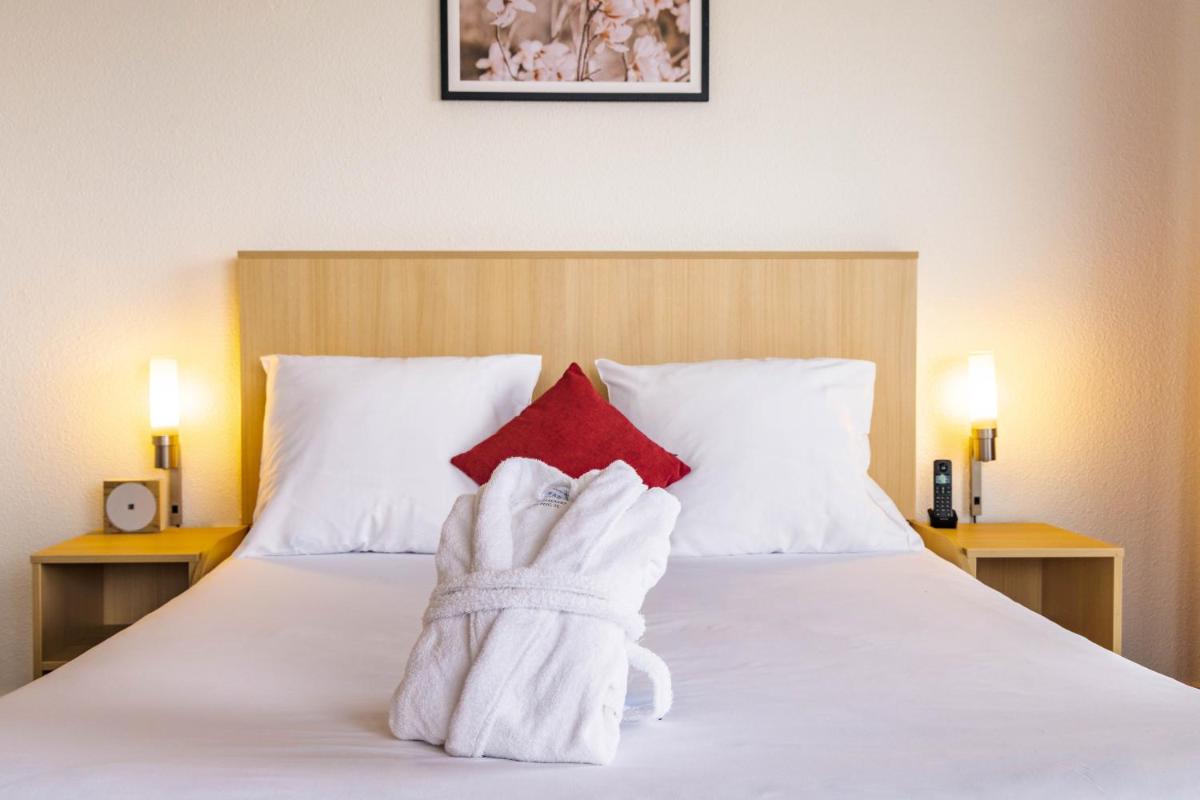 Un ou plusieurs lits dans un hébergement de l'établissement Novotel Senart Golf De Greenparc