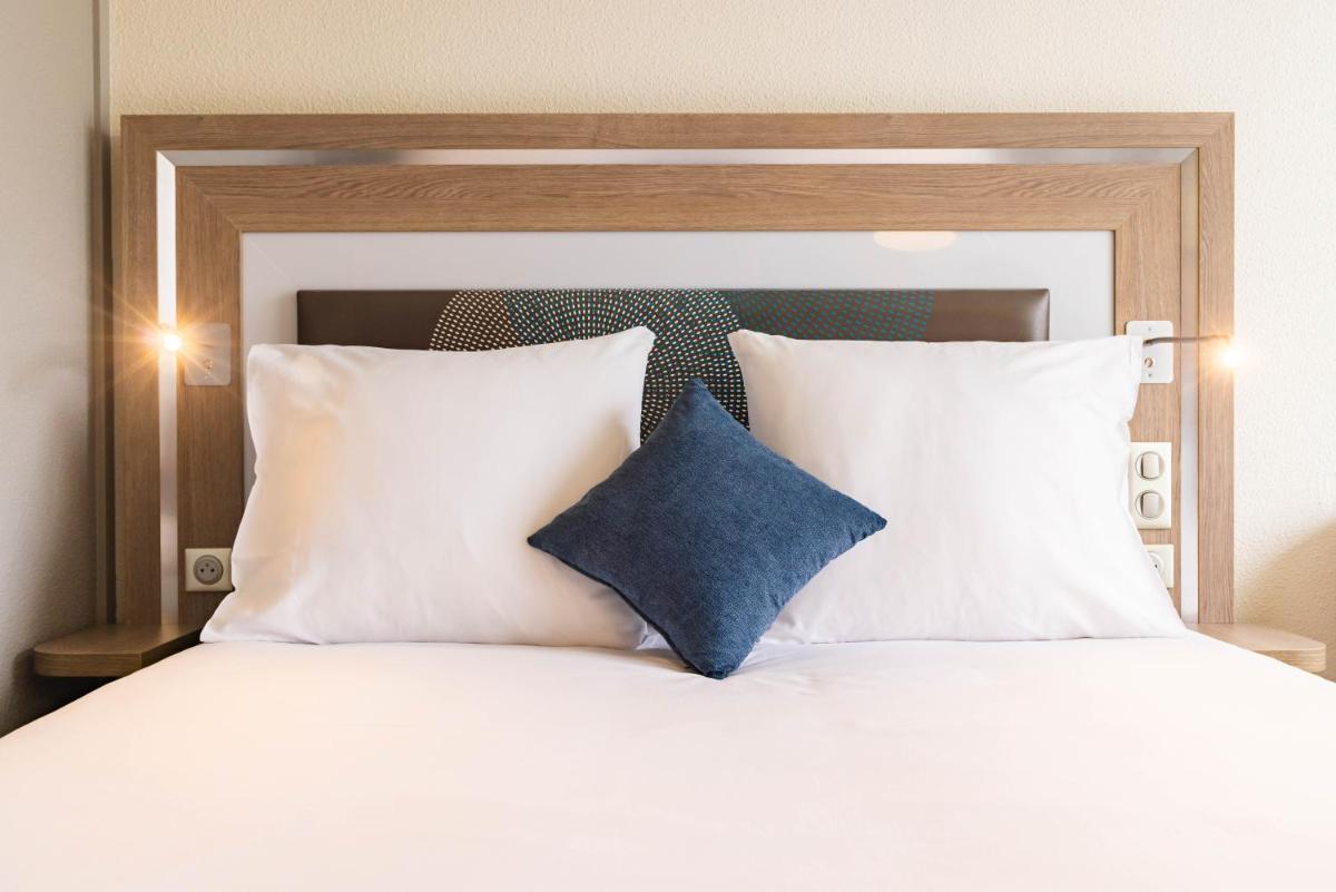 Un ou plusieurs lits dans un hébergement de l'établissement Novotel Senart Golf De Greenparc