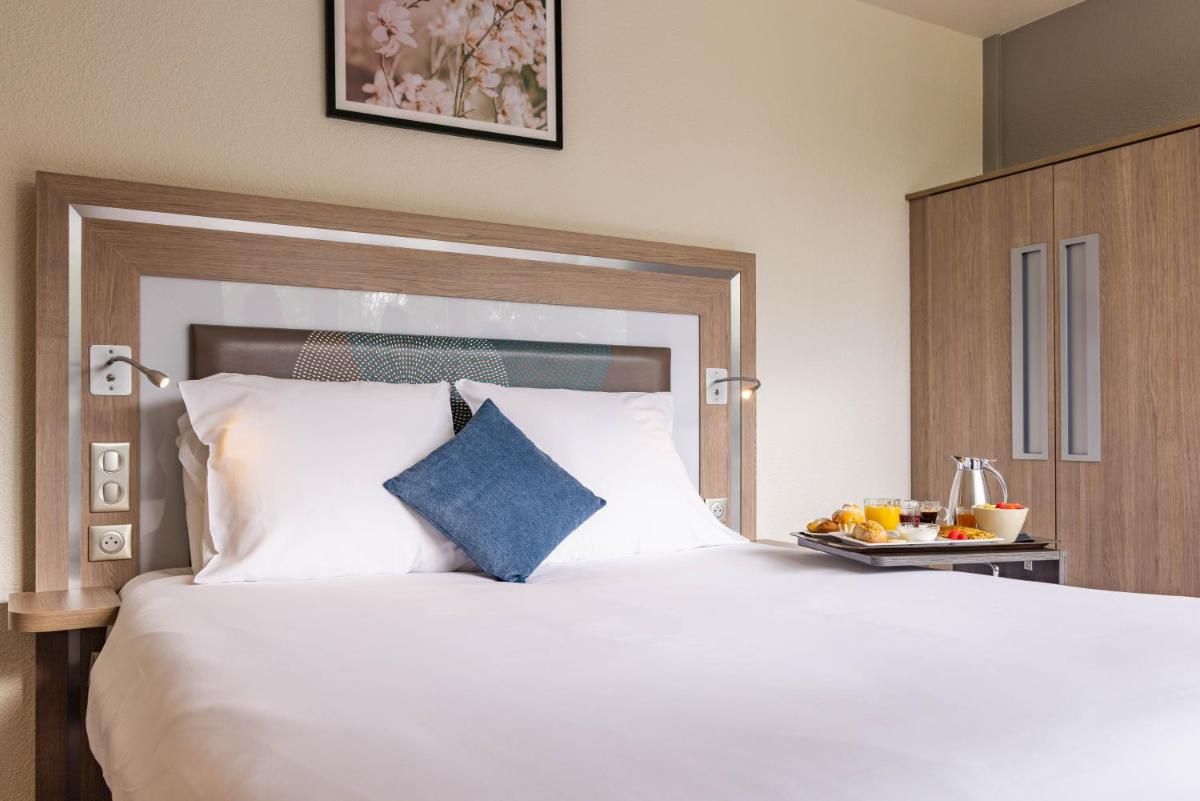 Un ou plusieurs lits dans un hébergement de l'établissement Novotel Senart Golf De Greenparc