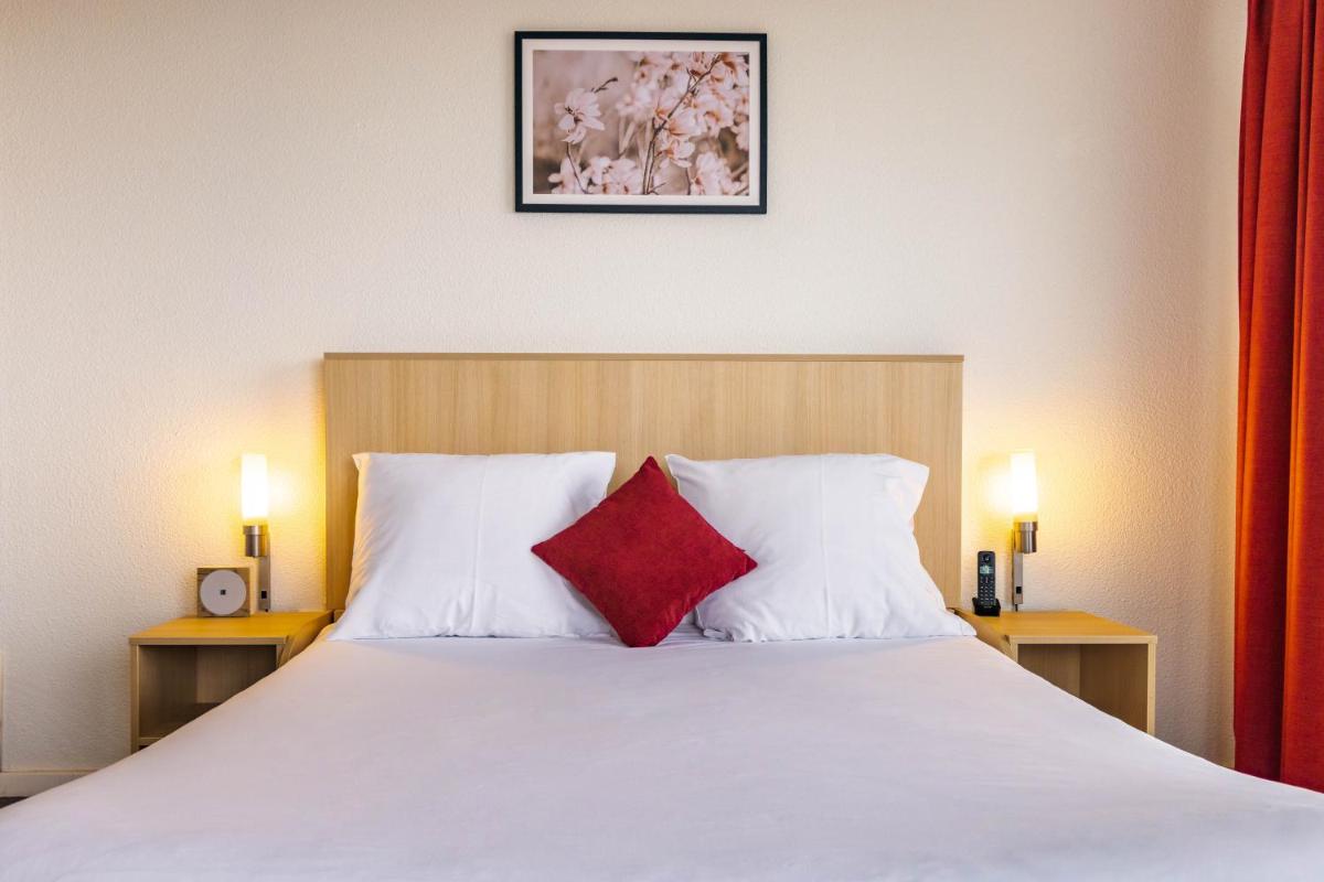 Un ou plusieurs lits dans un hébergement de l'établissement Novotel Senart Golf De Greenparc