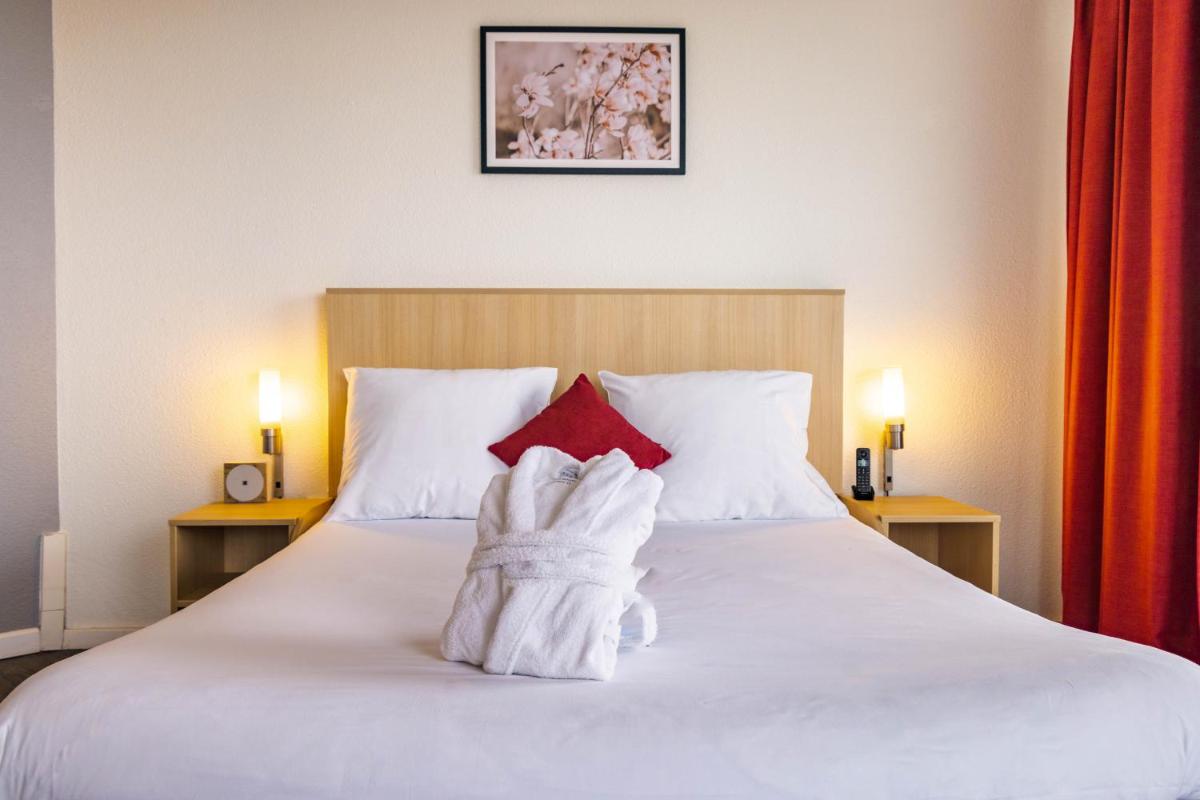 Un ou plusieurs lits dans un hébergement de l'établissement Novotel Senart Golf De Greenparc