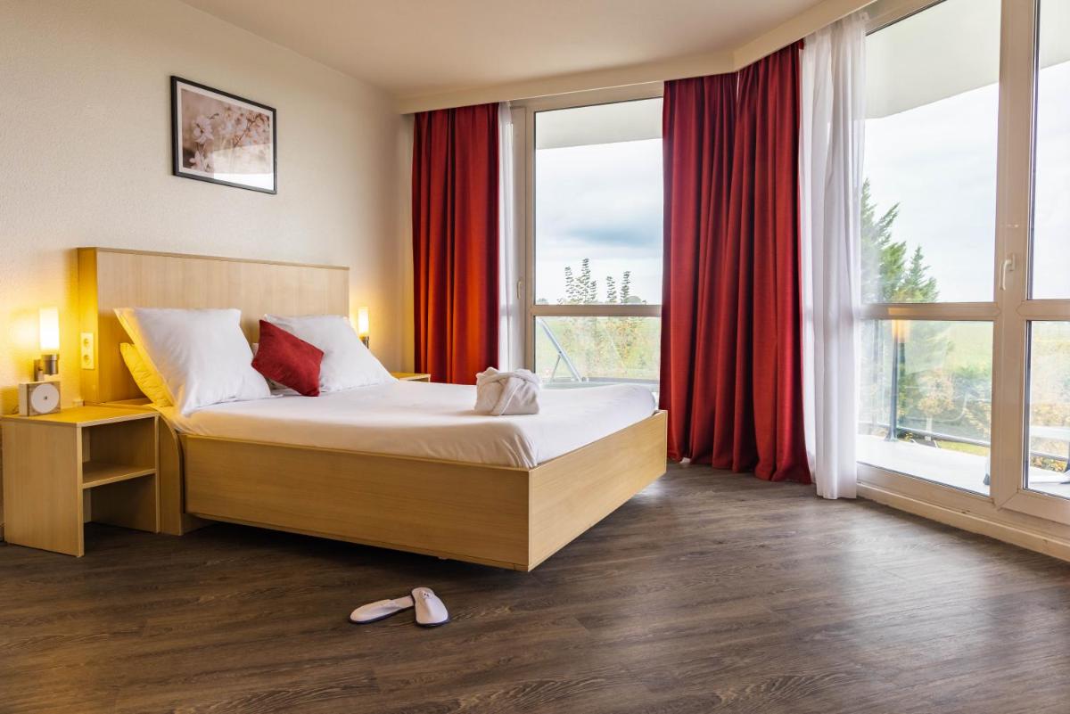 Un ou plusieurs lits dans un hébergement de l'établissement Novotel Senart Golf De Greenparc