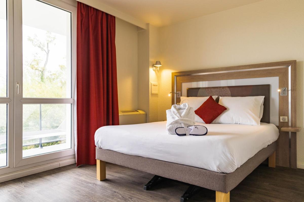 Un ou plusieurs lits dans un hébergement de l'établissement Novotel Senart Golf De Greenparc