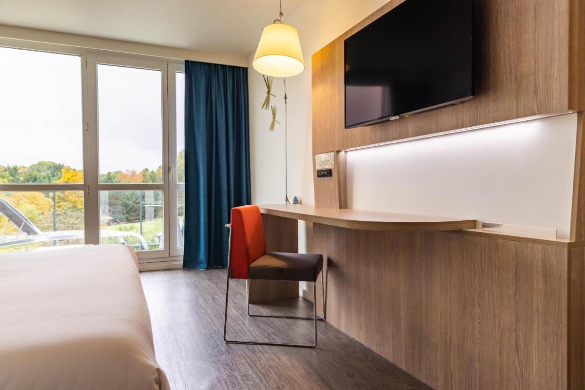 Télévision ou salle de divertissement dans l'établissement Novotel Senart Golf De Greenparc