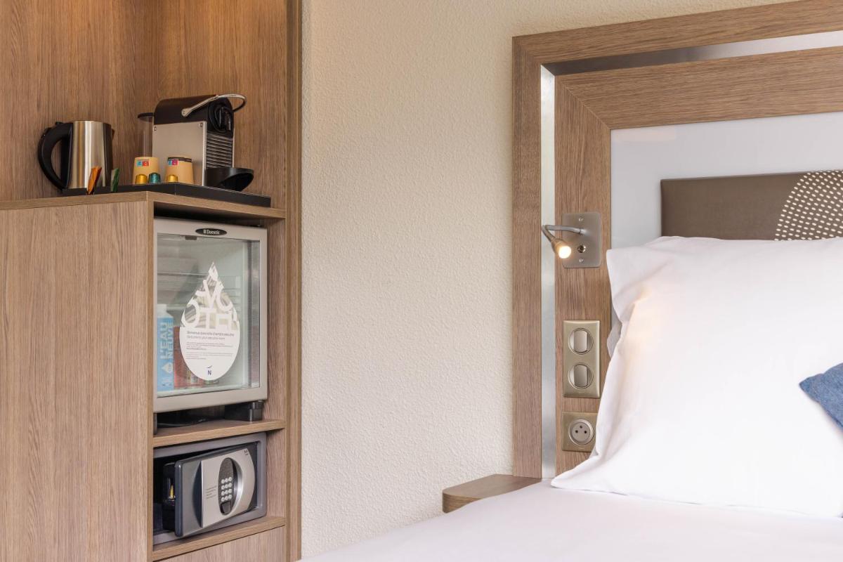Un ou plusieurs lits dans un hébergement de l'établissement Novotel Senart Golf De Greenparc