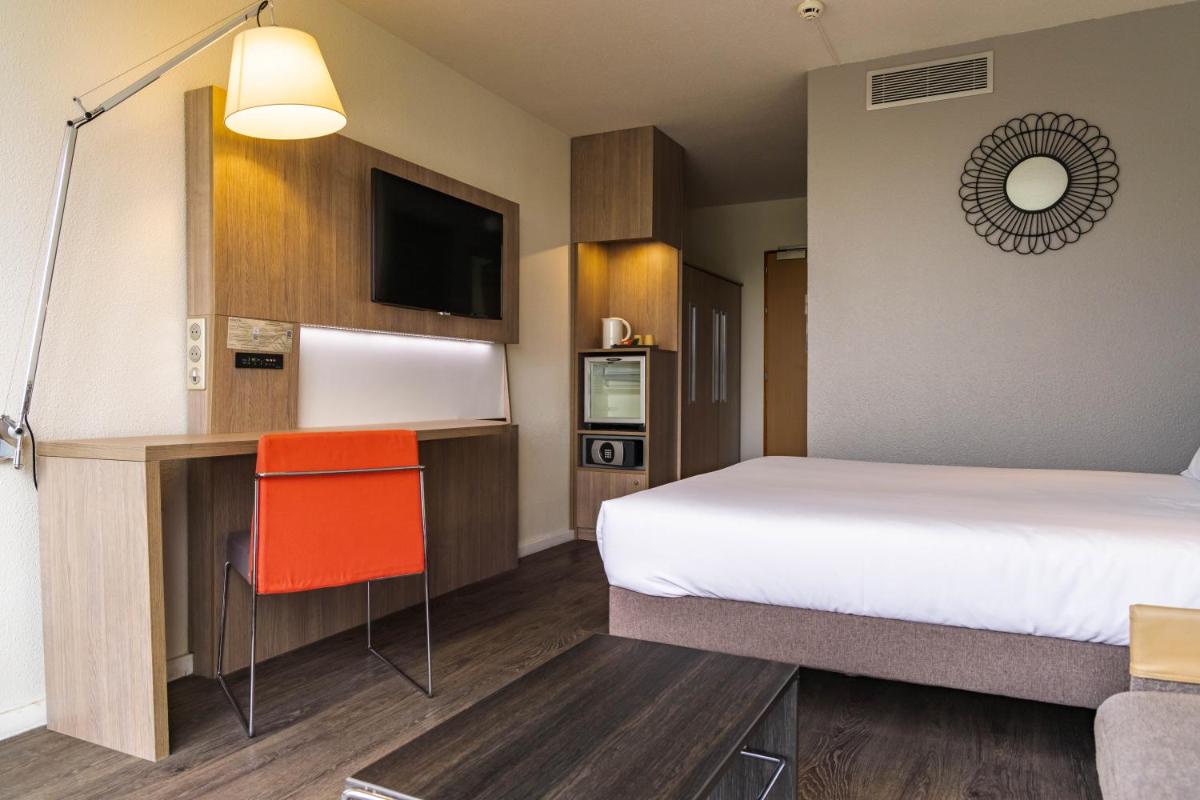Un ou plusieurs lits dans un hébergement de l'établissement Novotel Senart Golf De Greenparc