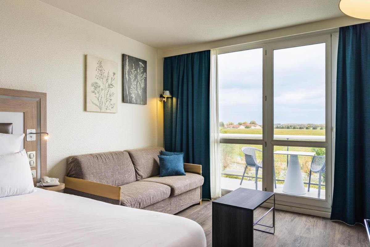 Un ou plusieurs lits dans un hébergement de l'établissement Novotel Senart Golf De Greenparc