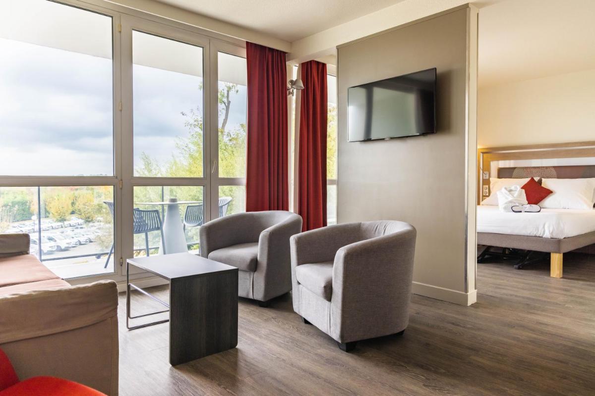 Un ou plusieurs lits dans un hébergement de l'établissement Novotel Senart Golf De Greenparc