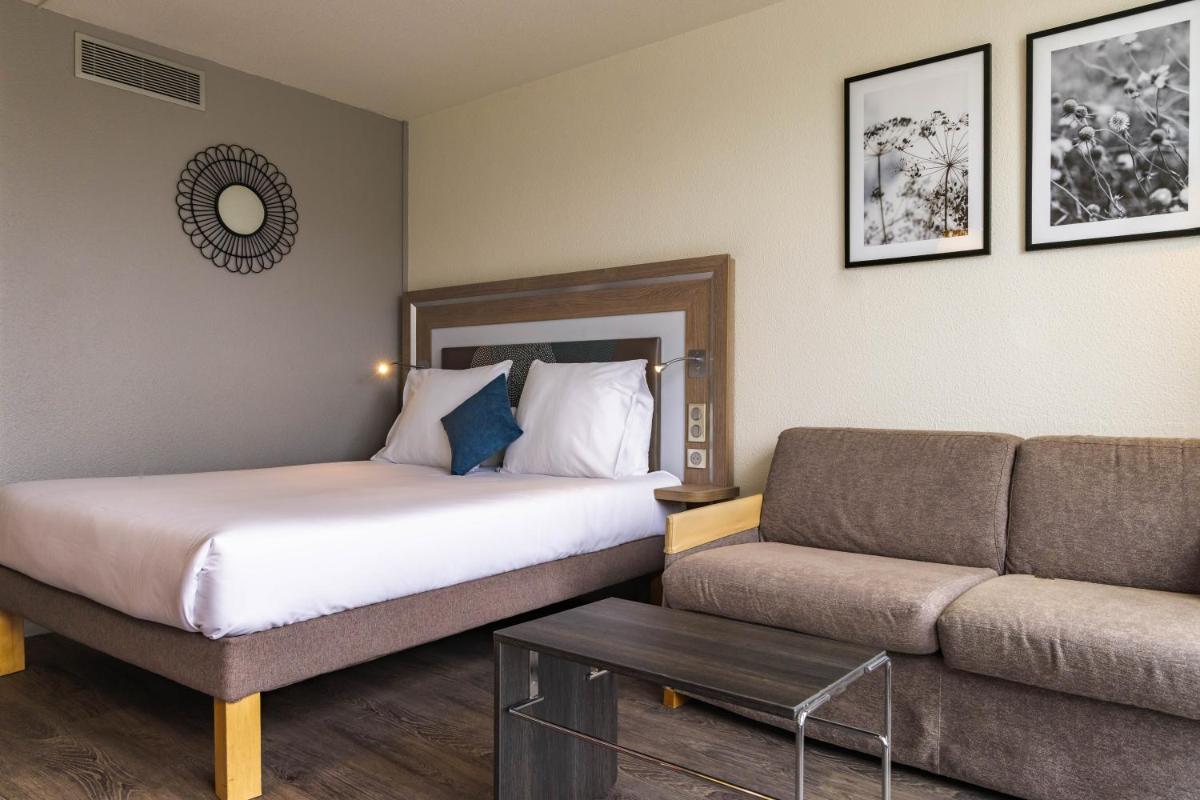 Un ou plusieurs lits dans un hébergement de l'établissement Novotel Senart Golf De Greenparc