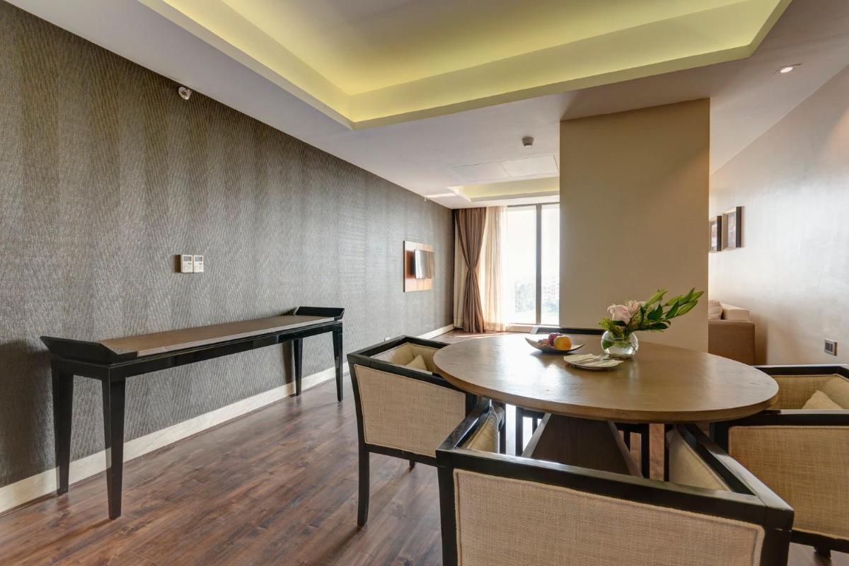 a dining room with a table and chairs at Holiday Inn Kolkata Airport by IHG in Kolkata