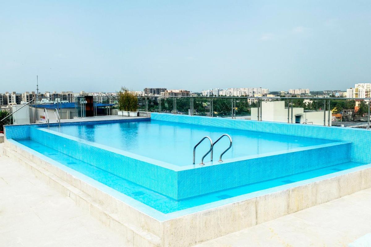 a swimming pool on the roof of a building at Holiday Inn Kolkata Airport by IHG in Kolkata