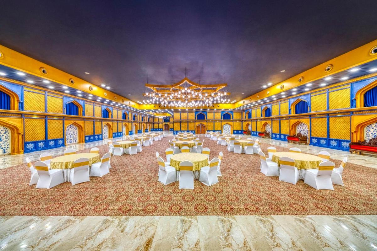 a large banquet hall with tables and a chandelier at Holiday Inn Kolkata Airport by IHG in Kolkata