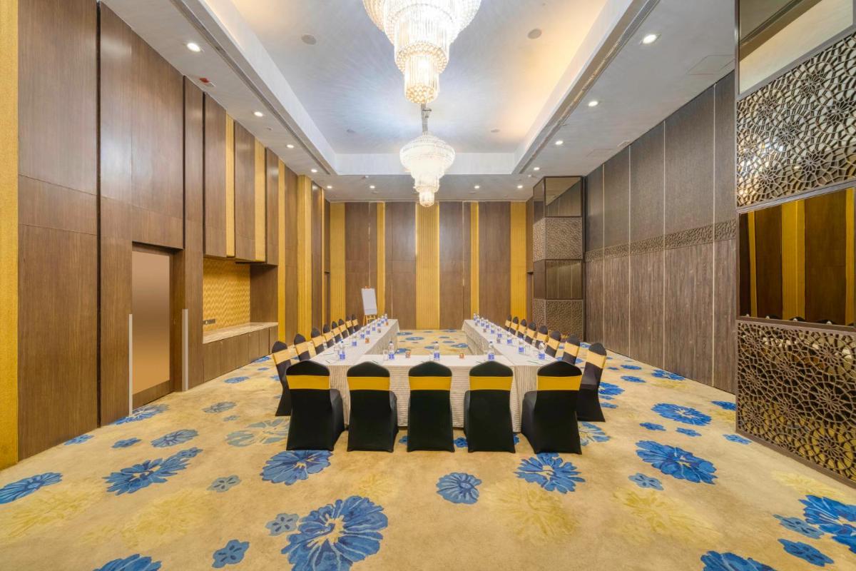 a conference room with a long table and chairs at Holiday Inn Kolkata Airport by IHG in Kolkata