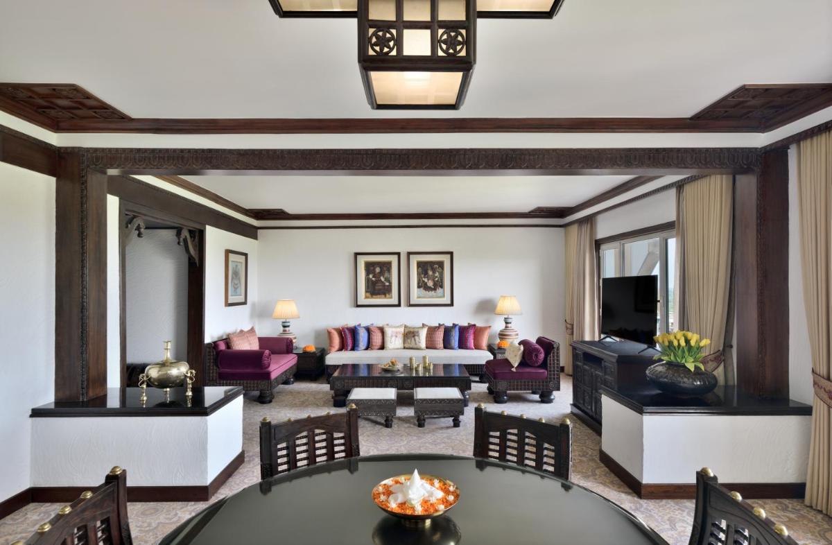 a living room with a couch and a table at Taj Mahal, New Delhi in New Delhi
