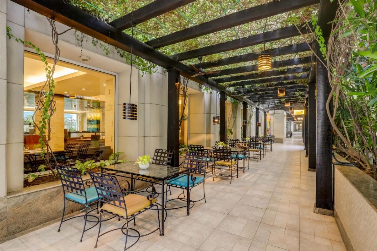 a row of tables and chairs on a patio at Lemon Tree Premier, Delhi Airport in New Delhi a row of tables and chairs on a patio at Lemon Tree Premier, Delhi Airport in New Delhi
