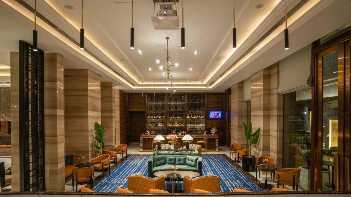 a lobby of a hotel with a couch and chairs at Crowne Plaza New Delhi Mayur Vihar Noida by IHG in New Delhi
