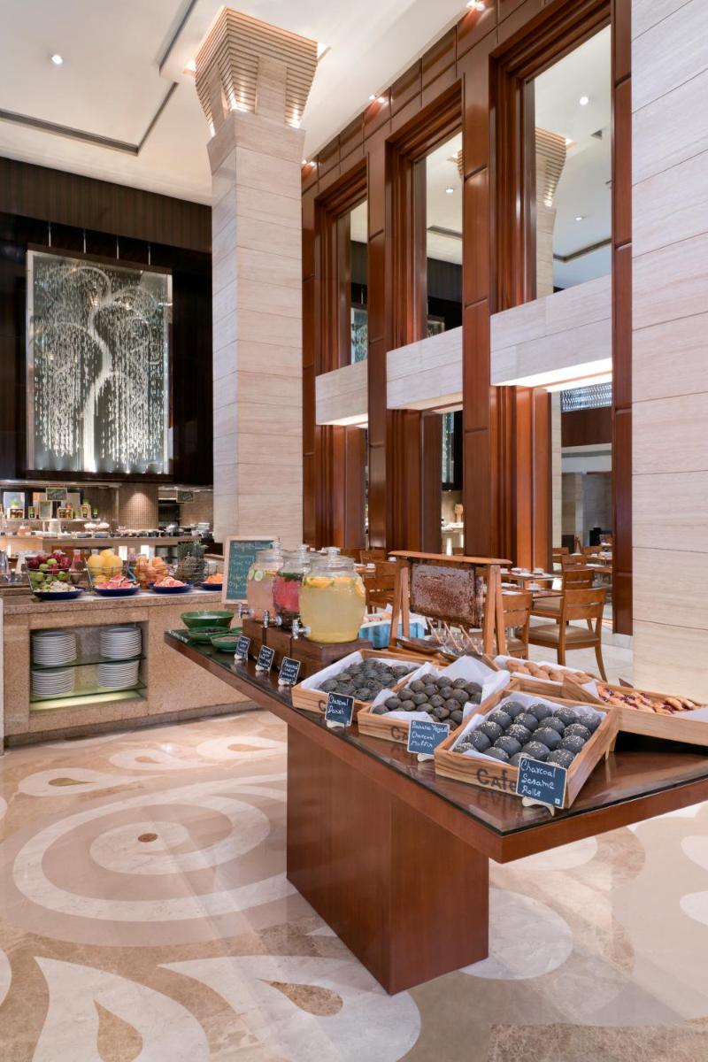 a buffet in a hotel lobby with food on display at Hyatt Regency Delhi in New Delhi a buffet in a hotel lobby with food on display at Hyatt Regency Delhi in New Delhi