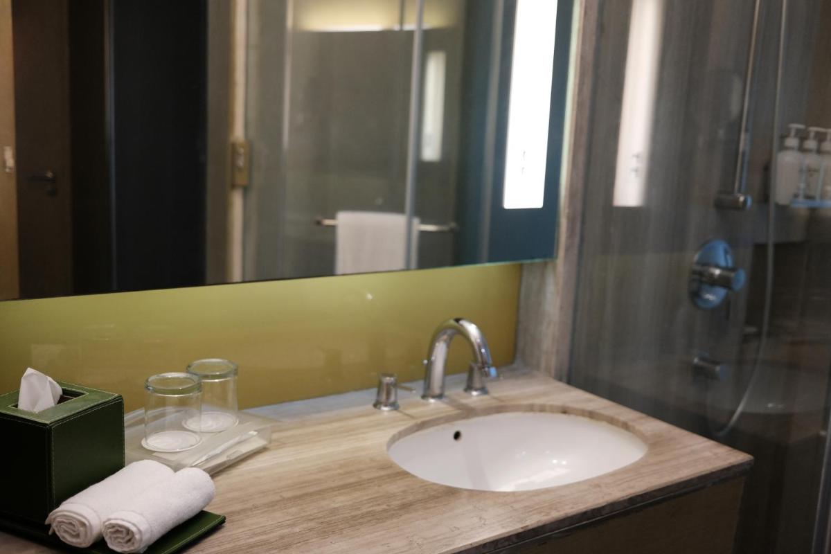 a bathroom counter with a sink and a mirror at Holiday Inn New Delhi Aerocity by IHG in New Delhi