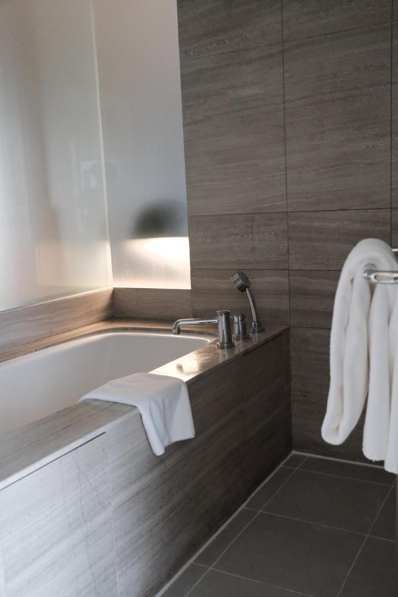 a bathroom with a bath tub and a sink at Holiday Inn New Delhi Aerocity by IHG in New Delhi