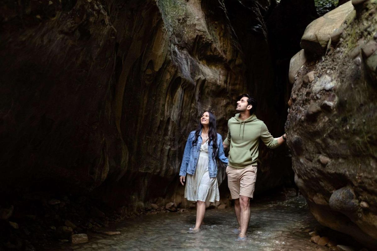 a man and a woman standing in a cave at Hyatt Regency Dehradun Resort and Spa in Dehradun