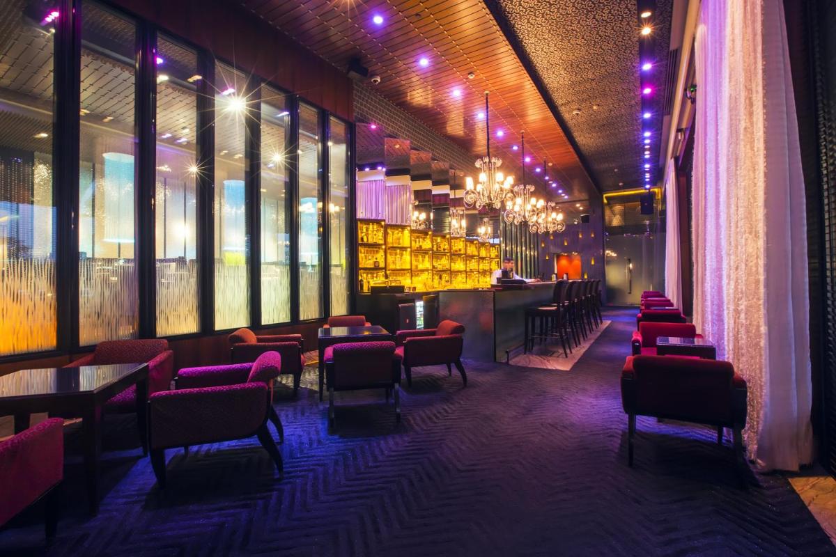 a restaurant with tables and chairs and a bar at Taj Palace, New Delhi in New Delhi a restaurant with tables and chairs and a bar at Taj Palace, New Delhi in New Delhi