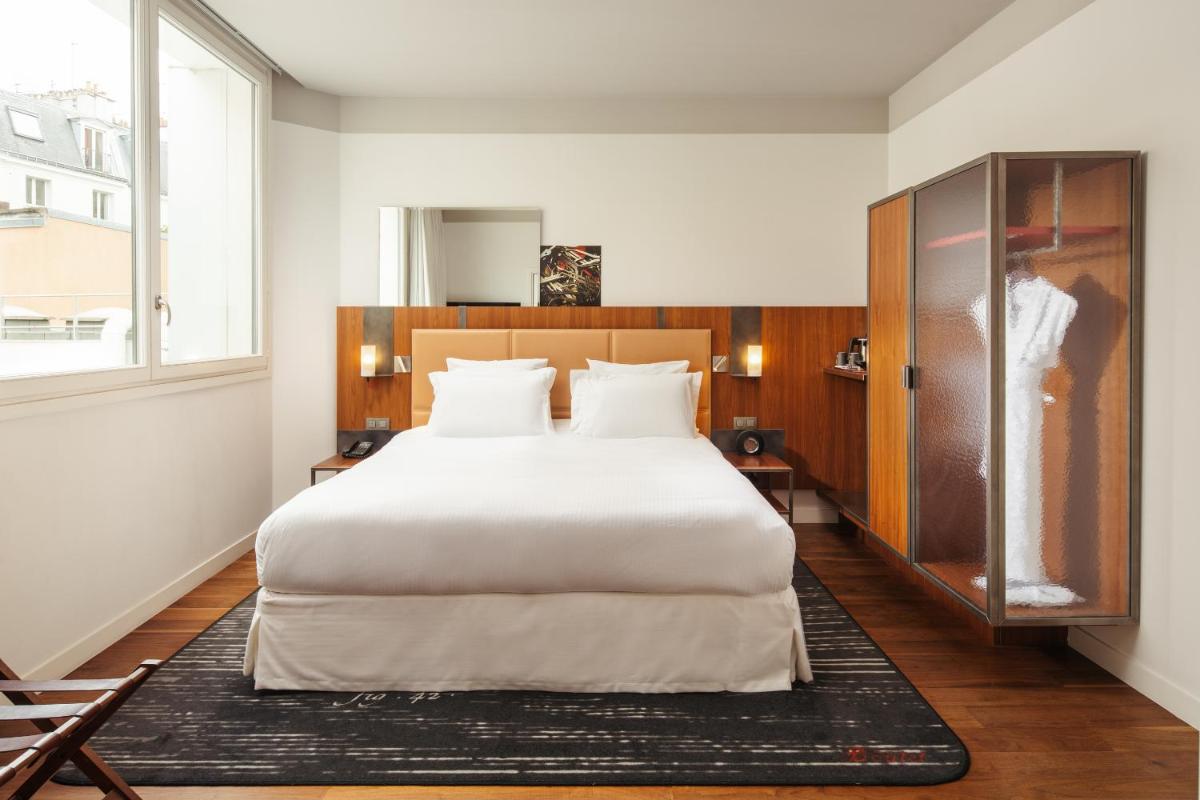 Un ou plusieurs lits dans un hébergement de l'établissement Boutet Bastille Hotel Paris - MGallery Collection