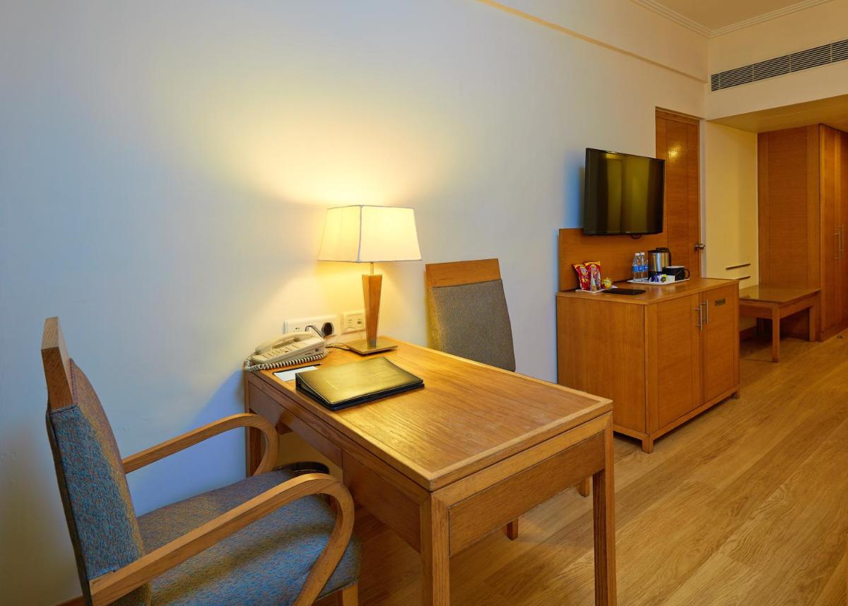 a hotel room with a desk and a telephone at Park Plaza Chennai OMR in Chennai