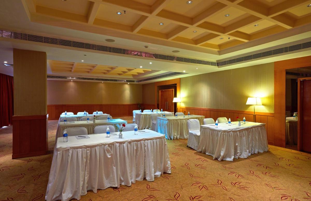 a banquet room with tables with white table covers at Park Plaza Chennai OMR in Chennai