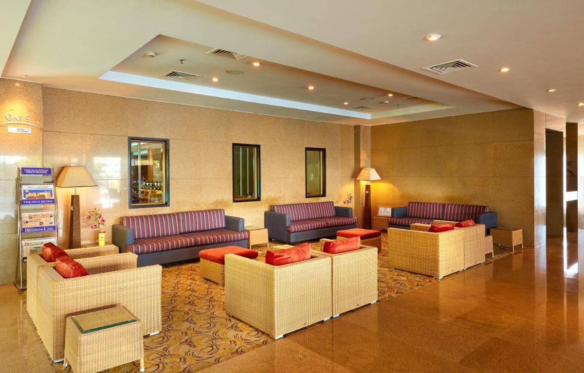 a lobby with couches and chairs in a hotel at Park Plaza Chennai OMR in Chennai