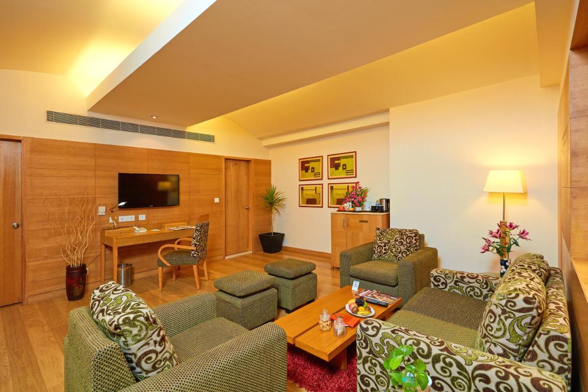 a living room with a couch and chairs and a table at Park Plaza Chennai OMR in Chennai