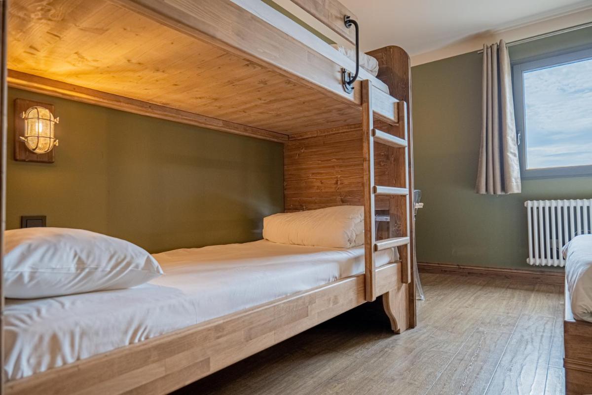 Un ou plusieurs lits dans un hébergement de l'établissement La Maison Rouge