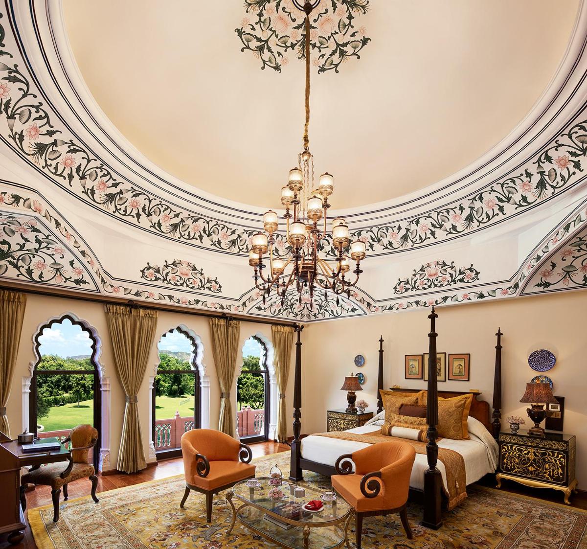 a bedroom with a domed ceiling and a bed with a chandelier at Rambagh Palace in Jaipur a bedroom with a domed ceiling and a bed with a chandelier at Rambagh Palace in Jaipur