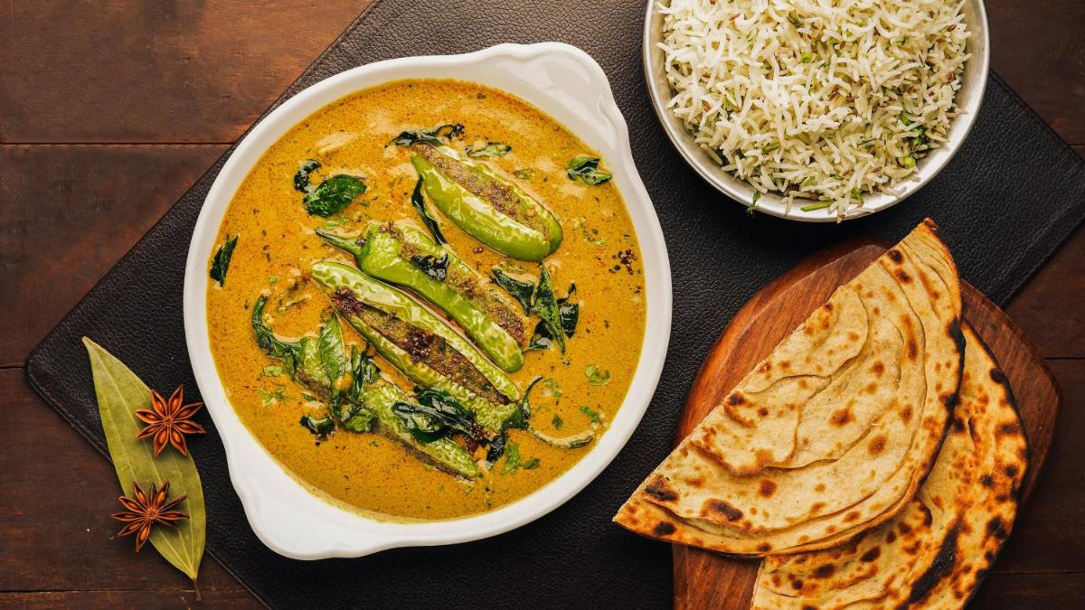 a table with a bowl of soup and a bowl of rice at InterContinental Marine Drive Mumbai by IHG in Mumbai