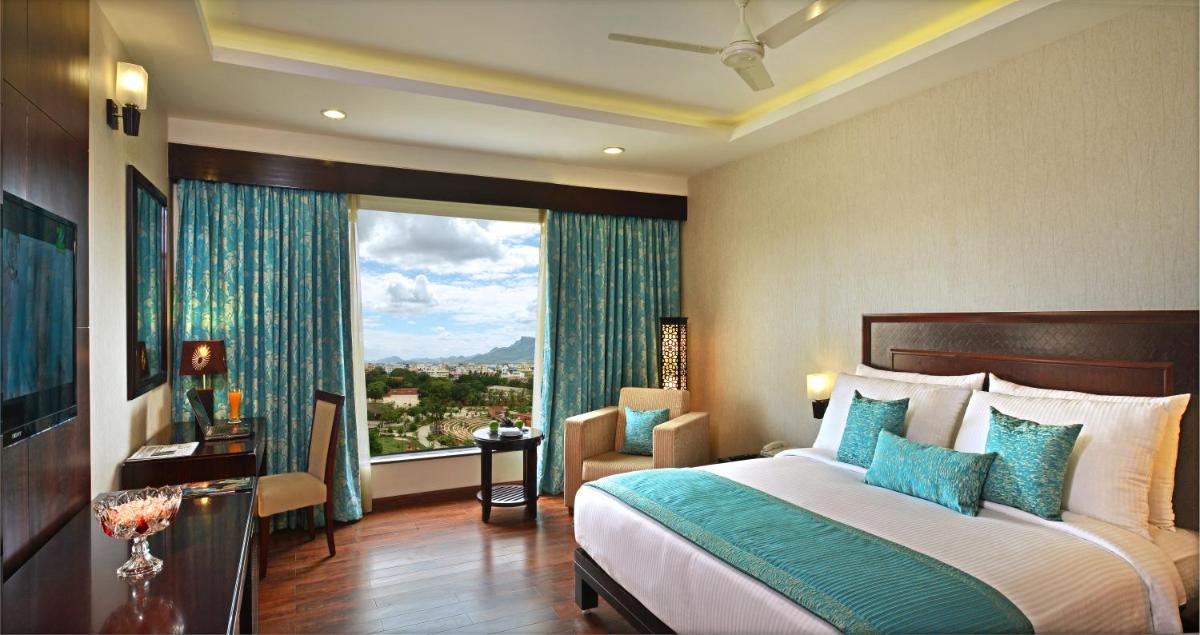 a bedroom with a bed and a large window at Fortune Select Grand Ridge, Tirupati - Member ITC Hotels' Group in Tirupati